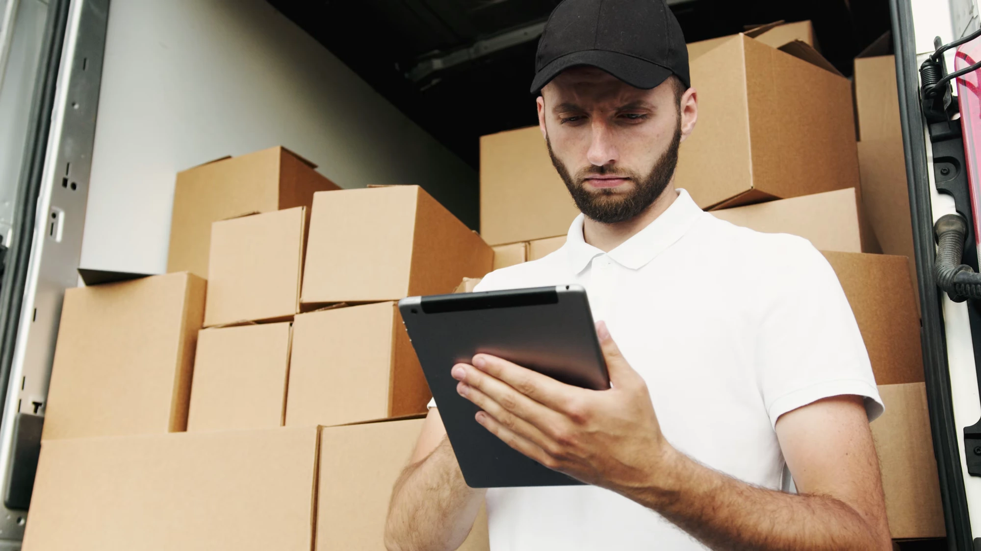 Delivery driver with packages and tablet